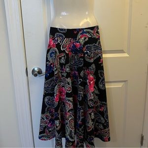 thick material, has pockets, navy blue background with pink paisley design